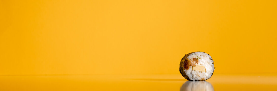 Sushi roll isolated on yellow background.