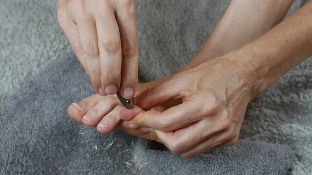 Trimming the cuticles of toenails. Removal of old skin on toes.