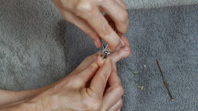 Trimming the cuticles of toenails. Removal of old skin on toes.