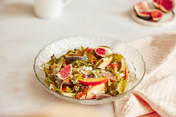 Fresh autumn salad with fresh arugula, grain cheese, batata and figs. Healthy appetizer, fresh vegan salad
