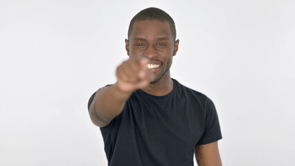 Young African Man Pointing at Camera on White Background