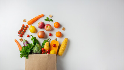 Delivery healthy food background. Healthy vegan vegetarian food in paper bag vegetables and fruits on white, copy space, banner. Shopping food supermarket and clean vegan eating concept
