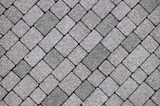 Fototapeta Grey brick stone street road. Light sidewalk, pavement texture