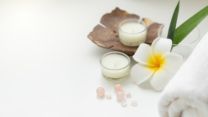 Fototapeta na wymiar Still life spa setting with pink stone aroma scent candle and plumeria flower. Thai spa massage. Spa treatment cosmetic beauty. Aromatherapy care relax wellness. Aroma and salt scrub healthy lifestyle