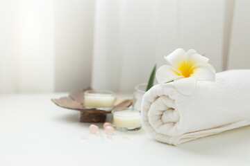 Obraz na płótnie Canvas Still life spa setting with pink stone aroma scent candle and plumeria flower. Thai spa massage. Spa treatment cosmetic beauty. Aromatherapy care relax wellness. Aroma and salt scrub healthy lifestyle