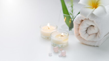 Still life spa setting with pink stone aroma scent candle and plumeria flower. Thai spa massage. Spa treatment cosmetic beauty. Aromatherapy care relax wellness. Aroma and salt scrub healthy lifestyle