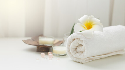 Naklejka na ściany i meble Still life spa setting with pink stone aroma scent candle and plumeria flower. Thai spa massage. Spa treatment cosmetic beauty. Aromatherapy care relax wellness. Aroma and salt scrub healthy lifestyle