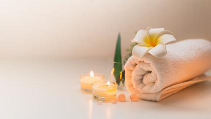 Still life spa setting with pink stone aroma scent candle and plumeria flower. Thai spa massage....