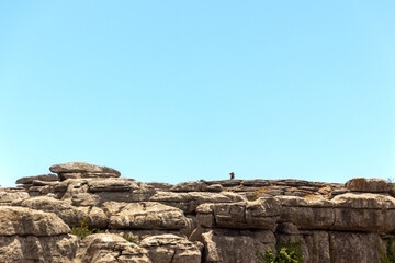 lonely man taking a photo on top of the mountain