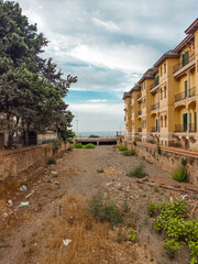 Dry riverbed in the city, dirty, litter, bridge in the background, drought, riverbed towards the sea, bridge in the background