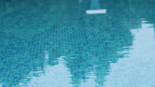 Surface of blue swimming pool. Wavy water surface of swimming pool