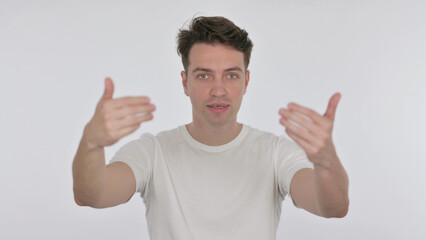 Fototapeta premium Inviting Young Man Pointing at Camera on White Background