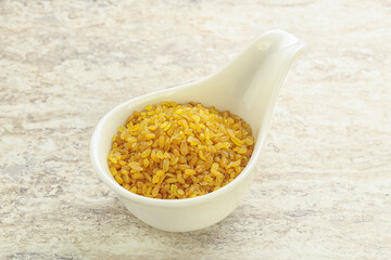 Raw bulgur in the bowl