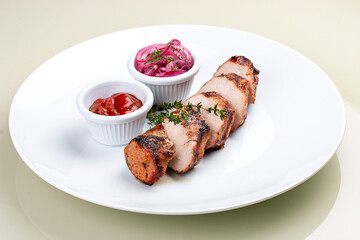 Grilled pork sliced with tomato sauce and pickled onions. Isolated on a white background
