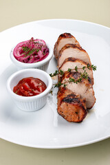 Grilled pork sliced with tomato sauce and pickled onions. Isolated on a white background