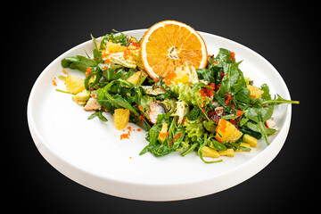 Juicy salad with arugula , orange and avocado. On a light background.
