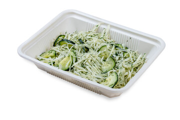 Salad with fresh cucumbers and grated cheese. In a plastic container. Food to go. On a light background.