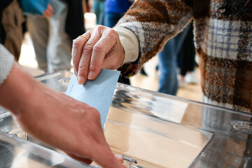 Illustration picture shows a person voting with a ballot paper in its envelope just before being...