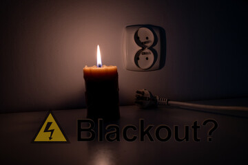 Blackout, candle with a socket, power cut - no electricity, the flame of a candle, circuit breaker,...