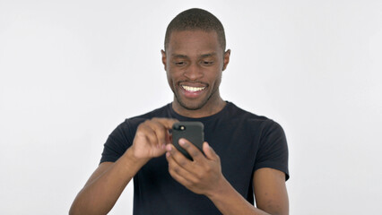 Young African Man Browsing Smartphone on White Background