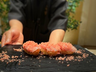 Japanese Omakase : Close up Otoro (Fatty Tuna) Sushi served on black plate. Japanese traditional luxury meal.