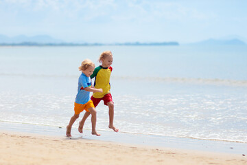 Naklejka premium Kids playing on beach. Children play at sea.