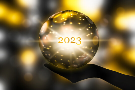 fortunetelling 2023 with a crystal ball in a hand, festive atmosphere for happy new year party or award ceremony or other celebrations, 3d illustration