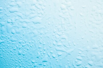 Cosmetic moisturizing liquid drops on green blue pastel background. Toner or lotion. Hyaluronic serum