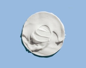 Face or body cream hair balm white on blue background