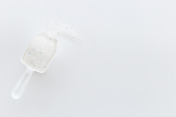 Obraz na płótnie Canvas Laundry detergents powder with scoop for washing machine