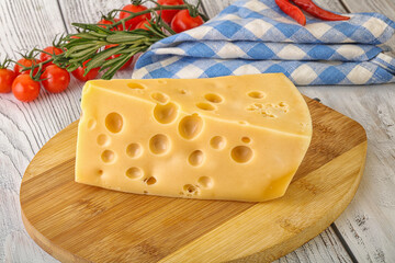 Maasdam cheese piece over board