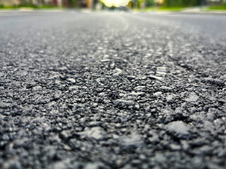 Grainy freshly laid asphalt in black close-up