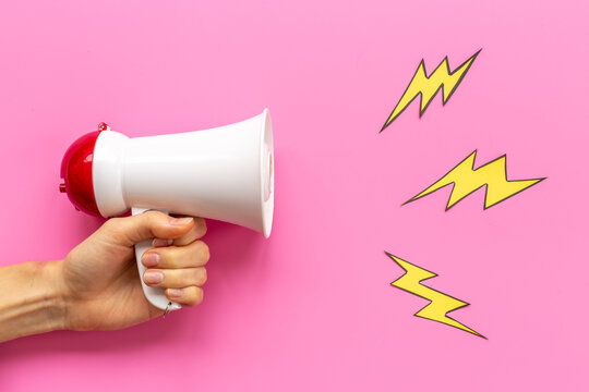 Attention concept. Hand holding megaphone for announcing hot news or advertising