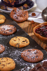 Cookies with chocolate and coffee on a wooden table, selective focus, close up
