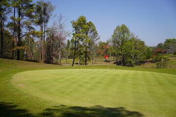 Background of evening golf course has sunlight shining down at golf course in Thailand.