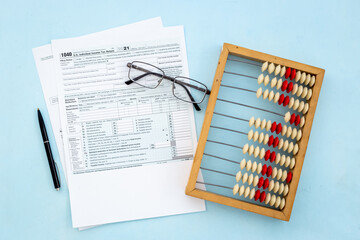Business tax calculations with accounting wooden abacus