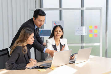 Fototapeta premium A group of young Asian businessmen Talking and planning work happily and have fun. at the company's office