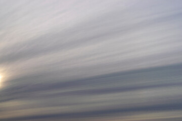 Fototapeta na wymiar Dramatic blue sky and warm light clouds at sunrise time.