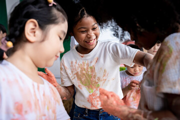 Asian girls and a group of friends are having fun together. Do color play activities to develop physically, intellectually and socially.