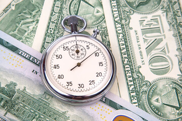 mechanical stopwatch on the background of dollars. Part time accuracy for business. business and finance time.
