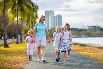 Mother and kids at sea shore in big city.
