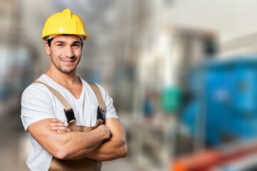 Portrait man worker supervisor with engineer safety suit work in large factory warehouse