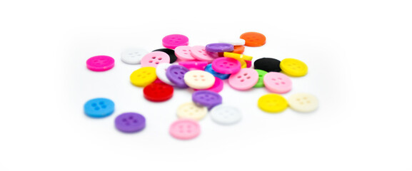 colorful various buttons on white background, soft and selective focus.