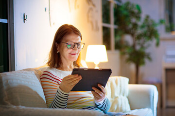 Woman with smart phone at home.