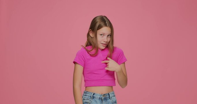 Not me. Funny child girl pointing to herself, showing stop gesture, saying no, declining suggestion on pink background