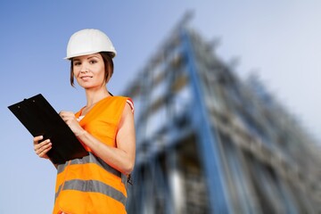 Portrait woman worker supervisor with engineer safety suit work in large factory warehouse