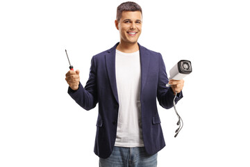 Fototapeta na wymiar Young man holding a cctv camera and a screwdriver