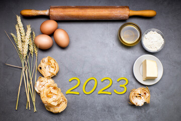 New Year 2023. Number 2023 on a blackboard with pasta making products