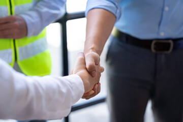 Fototapeta premium Architect shakes hands at meeting, meeting of two engineers or architects, shaking hands after discussion and meeting of new project plans, contracts for both companies, success, partnership