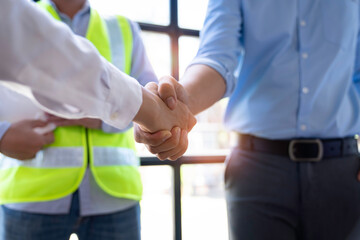 Architect shakes hands at meeting, meeting of two engineers or architects, shaking hands after discussion and meeting of new project plans, contracts for both companies, success, partnership